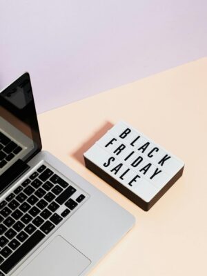 Minimalist laptop scene with black friday sale sign, perfect for retail marketing visuals.